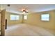Large bedroom with carpet, window, and access to another room at 1950 El Paso Trl, Bartow, FL 33830