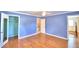 Light blue walls and hardwood floors in this bright bedroom at 1950 El Paso Trl, Bartow, FL 33830