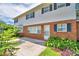 Brick and white home with a patio and lush landscaping at 1950 El Paso Trl, Bartow, FL 33830
