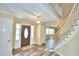 Two-story entryway with hardwood floors, curved staircase, and view to living area at 1950 El Paso Trl, Bartow, FL 33830