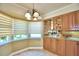 Kitchen with wood cabinets and granite counter at 1950 El Paso Trl, Bartow, FL 33830
