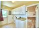 Laundry room with built-in cabinets, granite countertop, and exterior access at 1950 El Paso Trl, Bartow, FL 33830