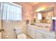 Bathroom with double vanity and large mirror at 1950 El Paso Trl, Bartow, FL 33830