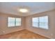 Bedroom with hardwood floors and two large windows with blinds at 1950 El Paso Trl, Bartow, FL 33830