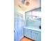 Bright laundry room with light blue cabinets and countertop at 1950 El Paso Trl, Bartow, FL 33830