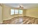 Spacious living room with hardwood floors, bay window, and ceiling fan at 1950 El Paso Trl, Bartow, FL 33830