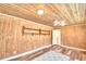 Bright sunroom features wood walls, brick accent wall, and ceiling fan at 1950 El Paso Trl, Bartow, FL 33830