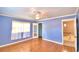 Spacious bedroom with light blue walls, hardwood floors and a large closet at 1950 El Paso Trl, Bartow, FL 33830