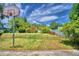 Large backyard with basketball hoop and mature trees at 1950 El Paso Trl, Bartow, FL 33830