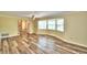 Bright living room with hardwood floors, bay window, and access to other rooms at 1950 El Paso Trl, Bartow, FL 33830