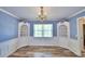 Elegant dining room with hardwood floors, built-in corner cabinets, and chandelier at 1950 El Paso Trl, Bartow, FL 33830