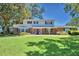 Two-story house with brick and white siding, large yard at 1950 El Paso Trl, Bartow, FL 33830