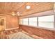 Sunroom with wood walls, brick wall, and window blinds at 1950 El Paso Trl, Bartow, FL 33830