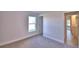 Well-lit bedroom with carpet flooring and access to a bathroom at 4073 Tullamore Ln, Auburndale, FL 33823