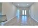 Spacious living area with tile floors and access to the backyard at 4073 Tullamore Ln, Auburndale, FL 33823