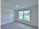Spacious bedroom with large window and carpeted floor at 4073 Tullamore Ln, Auburndale, FL 33823