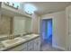 Double vanity bathroom with granite countertop and large mirror at 4073 Tullamore Ln, Auburndale, FL 33823