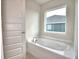Relaxing bathroom with soaking tub and window at 4073 Tullamore Ln, Auburndale, FL 33823