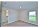 Bedroom with carpet, window, and access to a bathroom at 4073 Tullamore Ln, Auburndale, FL 33823