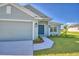 Close up view of a home's exterior, showcasing the front entrance and landscaping at 4073 Tullamore Ln, Auburndale, FL 33823