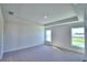 Carpeted bedroom with two windows and neutral walls at 4073 Tullamore Ln, Auburndale, FL 33823