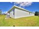 Side view of house showcasing light teal exterior and landscaping at 4073 Tullamore Ln, Auburndale, FL 33823