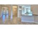 Open kitchen with island, granite countertops, and white cabinets at 4073 Tullamore Ln, Auburndale, FL 33823