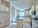Bright kitchen, white cabinets, granite countertops, and kitchen island at 4073 Tullamore Ln, Auburndale, FL 33823