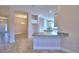 Open kitchen with white cabinets, granite countertops, and an island at 4073 Tullamore Ln, Auburndale, FL 33823