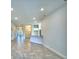 Open living area with tile floors and views to kitchen and entry at 4073 Tullamore Ln, Auburndale, FL 33823
