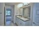 Double vanity bathroom with granite countertop and large mirror at 4073 Tullamore Ln, Auburndale, FL 33823