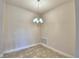 Bright dining room with tile floor and modern chandelier at 4073 Tullamore Ln, Auburndale, FL 33823