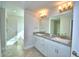 Double vanity bathroom with granite countertops and a bathtub at 4073 Tullamore Ln, Auburndale, FL 33823