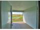 Covered patio with serene views of a pond and conservation area at 4073 Tullamore Ln, Auburndale, FL 33823