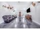 Open concept living room with high ceilings, concrete floors, and mounted TV at 12510 Lake Hatchineha Rd, Haines City, FL 33844