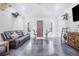 Spacious living area with dark leather couches and stained concrete floors at 12510 Lake Hatchineha Rd, Haines City, FL 33844