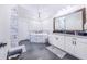 Spa-like bathroom with a soaking tub, double vanity, and a large mirror at 12510 Lake Hatchineha Rd, Haines City, FL 33844