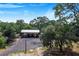 Metal carport structure in a wooded area at 12510 Lake Hatchineha Rd, Haines City, FL 33844