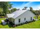White farmhouse with metal roof and well manicured lawn at 12510 Lake Hatchineha Rd, Haines City, FL 33844
