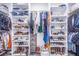 Walk-in closet with ample shelving and hanging space for clothes and shoes at 12510 Lake Hatchineha Rd, Haines City, FL 33844