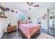 Cozy bedroom with a queen bed, ceiling fan, and ensuite bathroom access at 12510 Lake Hatchineha Rd, Haines City, FL 33844