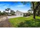 Modern farmhouse with metal roof, large backyard, and covered patio at 12510 Lake Hatchineha Rd, Haines City, FL 33844