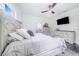 Spacious bedroom with a large bed, dresser, and ensuite bathroom access at 12510 Lake Hatchineha Rd, Haines City, FL 33844