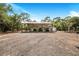 Open-air carport structure with small shed nearby at 12510 Lake Hatchineha Rd, Haines City, FL 33844