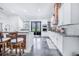 Modern kitchen with white cabinets, granite countertops, and a wood range hood at 12510 Lake Hatchineha Rd, Haines City, FL 33844