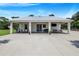 Modern farmhouse exterior with a metal roof and covered porch at 12510 Lake Hatchineha Rd, Haines City, FL 33844