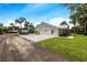 Modern farmhouse with metal roof, large backyard, and covered patio at 12510 Lake Hatchineha Rd, Haines City, FL 33844