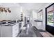 Modern kitchen with white cabinets, granite counters, stainless steel appliances, and concrete floors at 12510 Lake Hatchineha Rd, Haines City, FL 33844