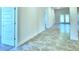Bright hallway with tile flooring and access to rooms at 2123 Cartgate Lane, Winter Haven, FL 33884