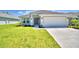 Attractive single-story house with a two-car garage and well-manicured lawn at 2123 Cartgate Lane, Winter Haven, FL 33884